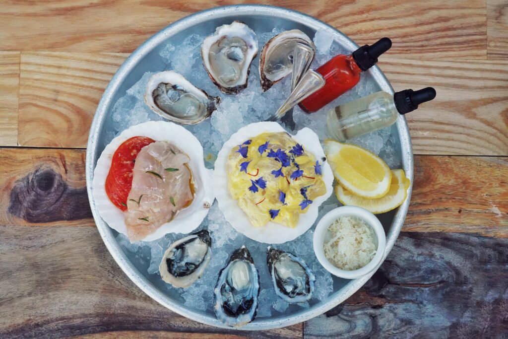 oysters, tartare, crudo, boquerones, horseradish, sauces and lemon over ice