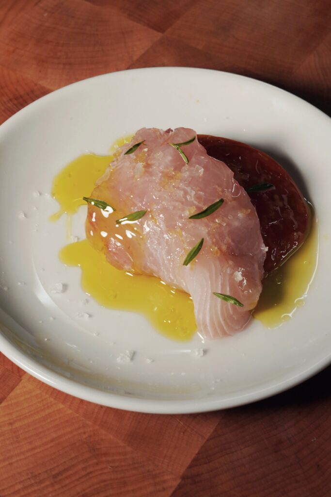 24 hour marinated in orange wine, early girl tomatoes, summer oregano, leek flowers and lemon 